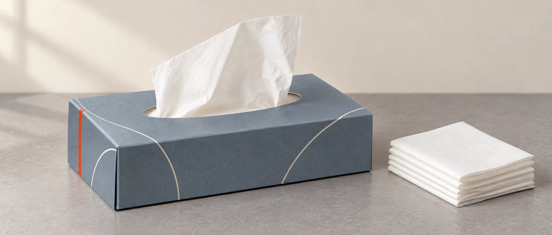AI packaging concept of a folding tissue carton beside a folded tissue stack