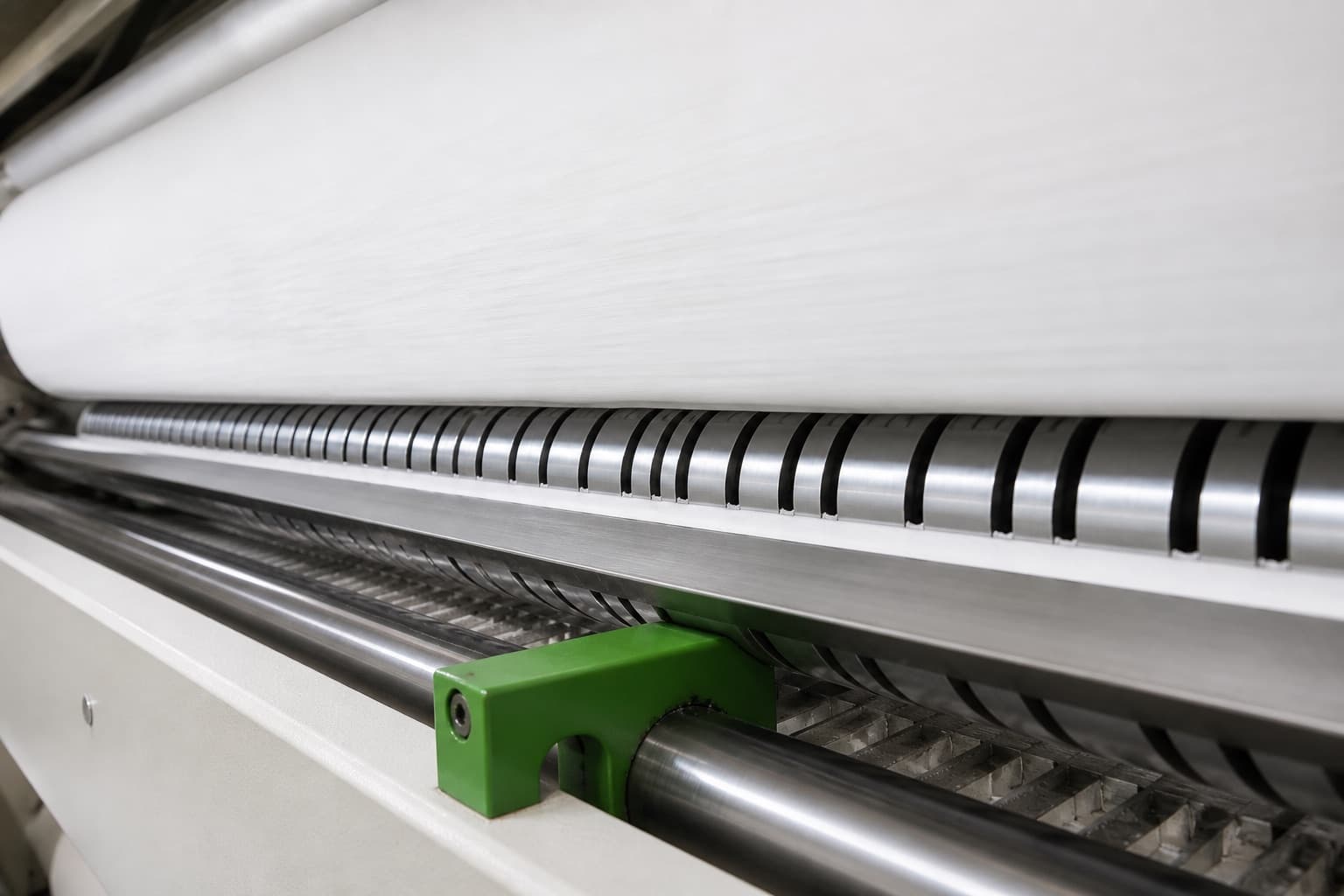 Close-up process visual developed from Jiufeng footage showing tissue web and slitting rollers