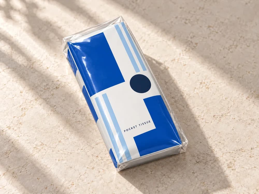 AI concept of a blue and white geometric pocket tissue wrapper with folded film edges