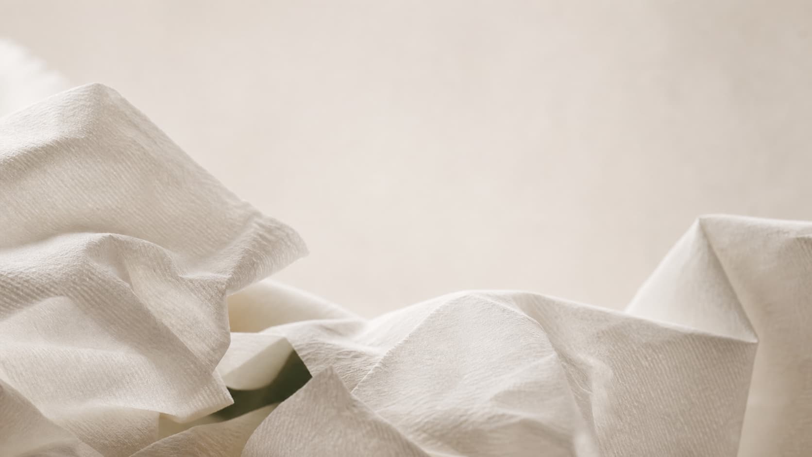 Close-up of folded white tissue paper with soft fiber texture for TISVEN contact inquiry